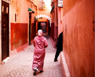 Kvinde klædt i lyserødt i gade i Marrakech