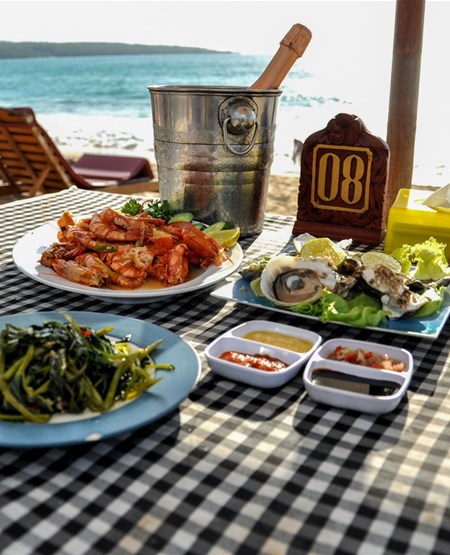 Restaurant med seafood og champagne på stranden i Jimbaran på Bali